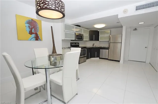 a kitchen with stainless steel appliances granite countertop a sink and a refrigerator