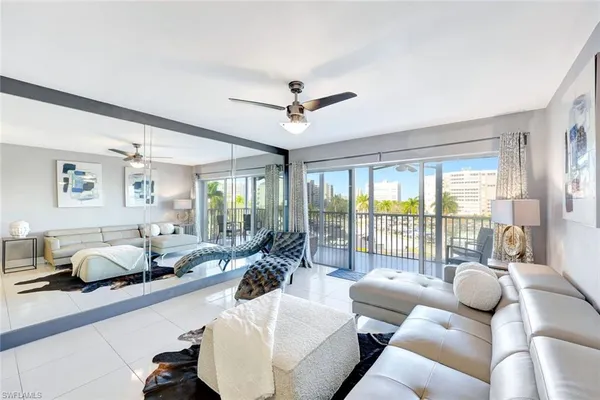 a living room with furniture and a large window with garden view
