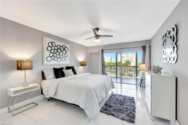 a bedroom with a bed and a lamp