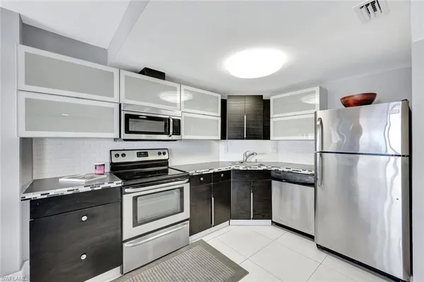a kitchen with a refrigerator stove and microwave