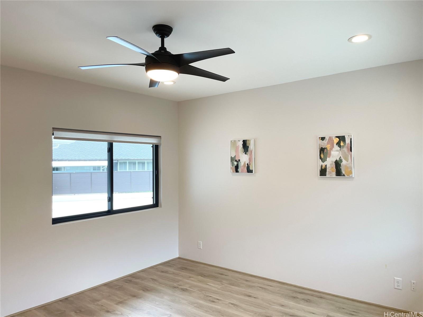 457 Halemaumau Street Honolulu, HI 96821 - Photo 11 of 25 a view of empty room with wooden floor and fan