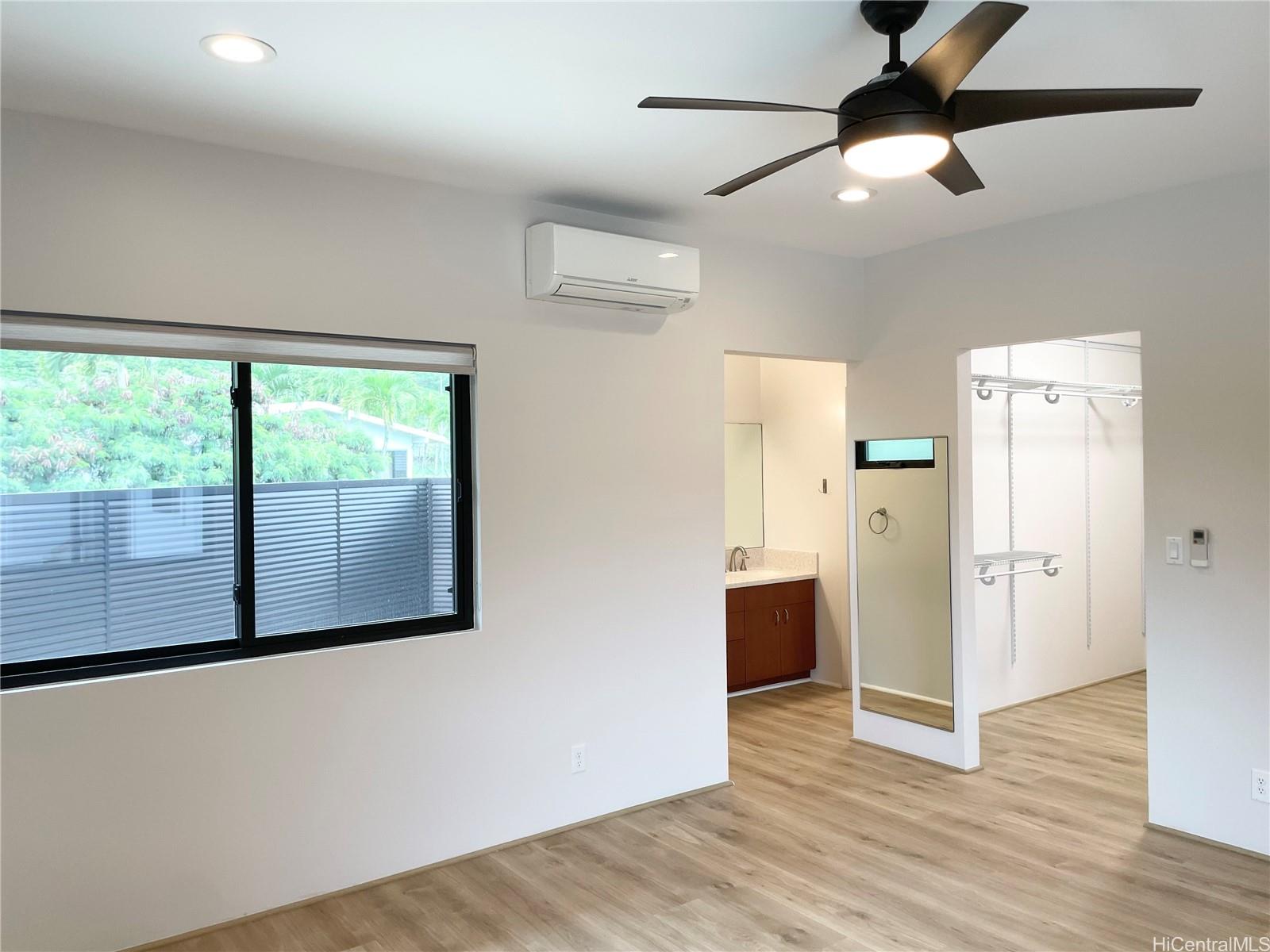 457 Halemaumau Street Honolulu, HI 96821 - Photo 12 of 25 a view of a livingroom with wooden floor and a ceiling fan