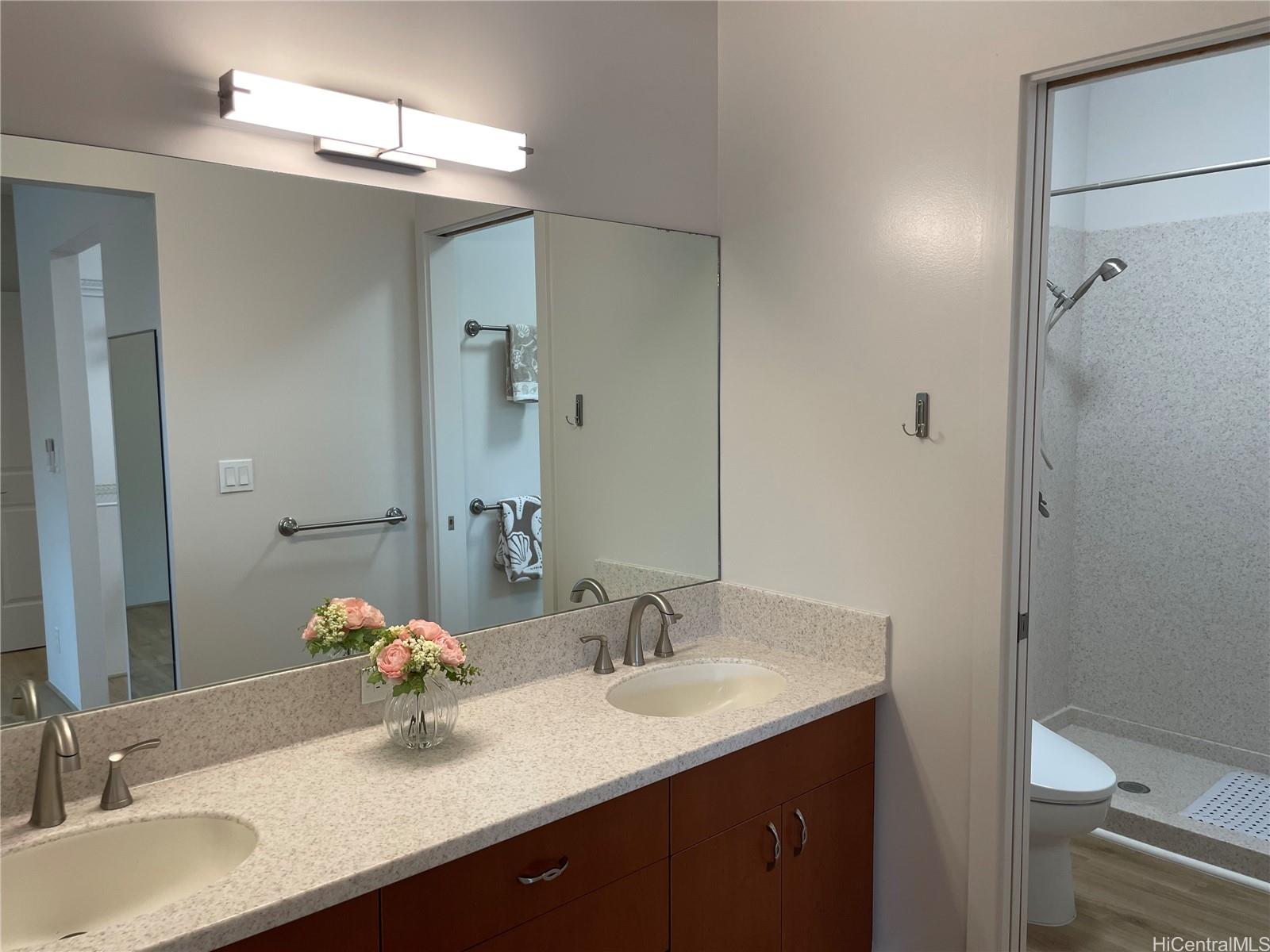 457 Halemaumau Street Honolulu, HI 96821 - Photo 13 of 25 a bathroom with a granite countertop sink and a mirror