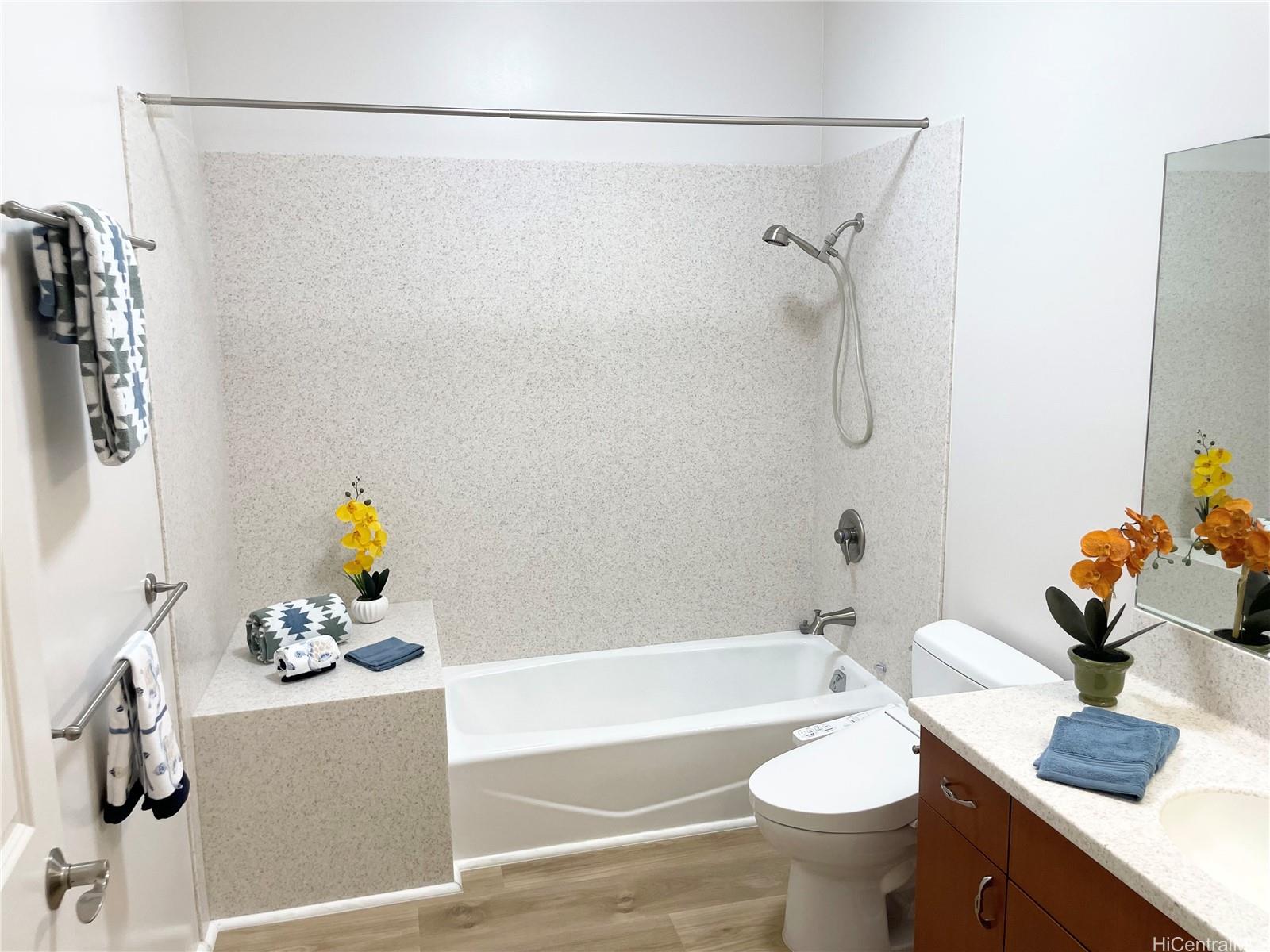 457 Halemaumau Street Honolulu, HI 96821 - Photo 16 of 25 a bathroom with a tub shower sink and toilet