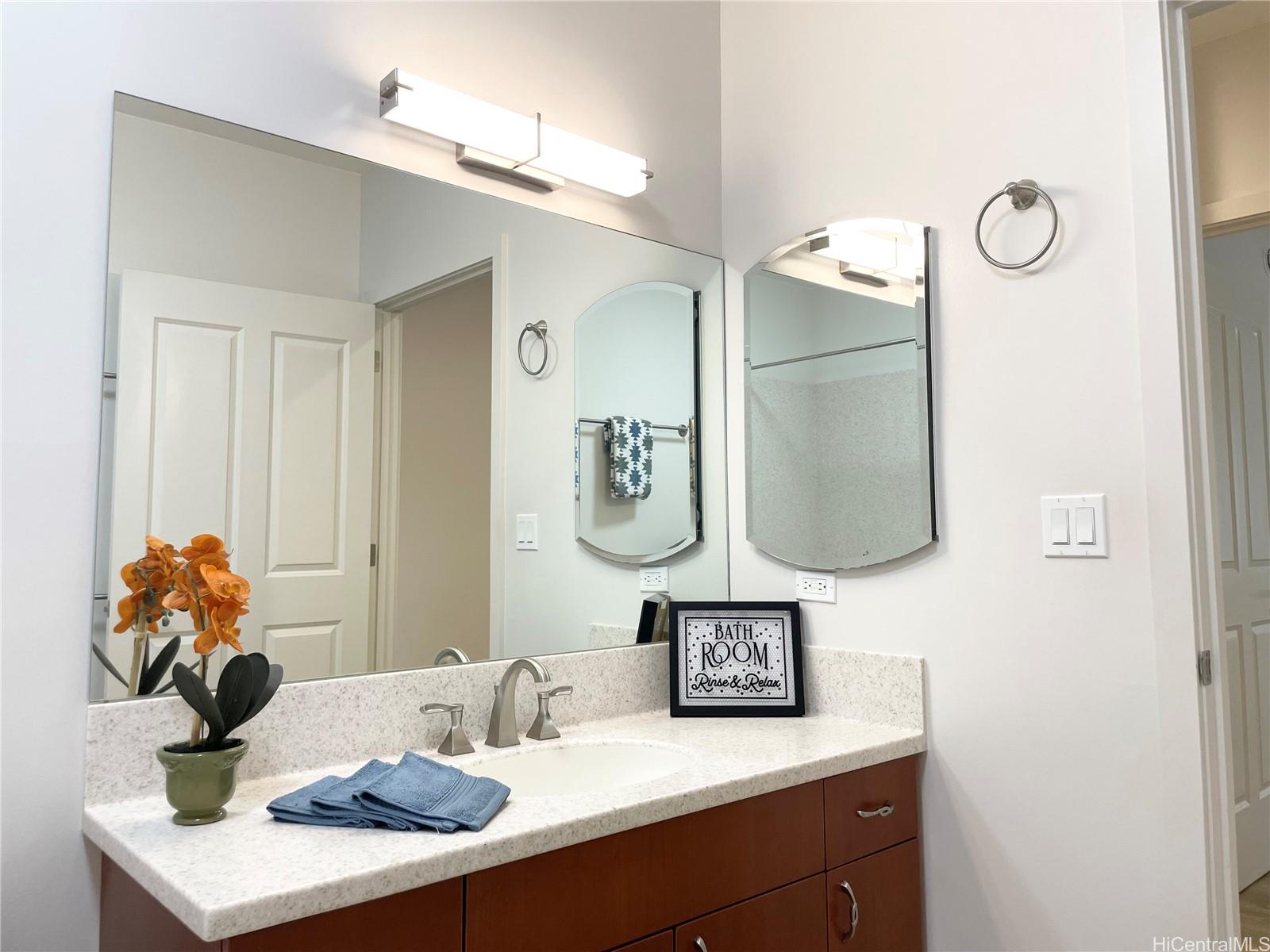 457 Halemaumau Street Honolulu, HI 96821 - Photo 17 of 25 a bathroom with a sink and a mirror