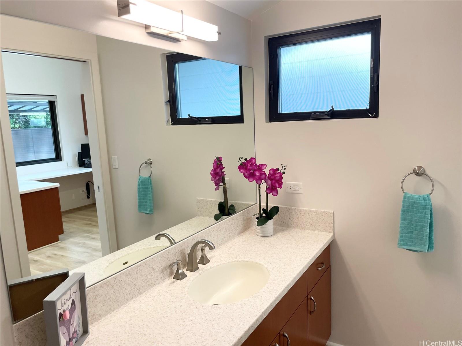 457 Halemaumau Street Honolulu, HI 96821 - Photo 19 of 25 a bathroom with a sink vanity and mirror