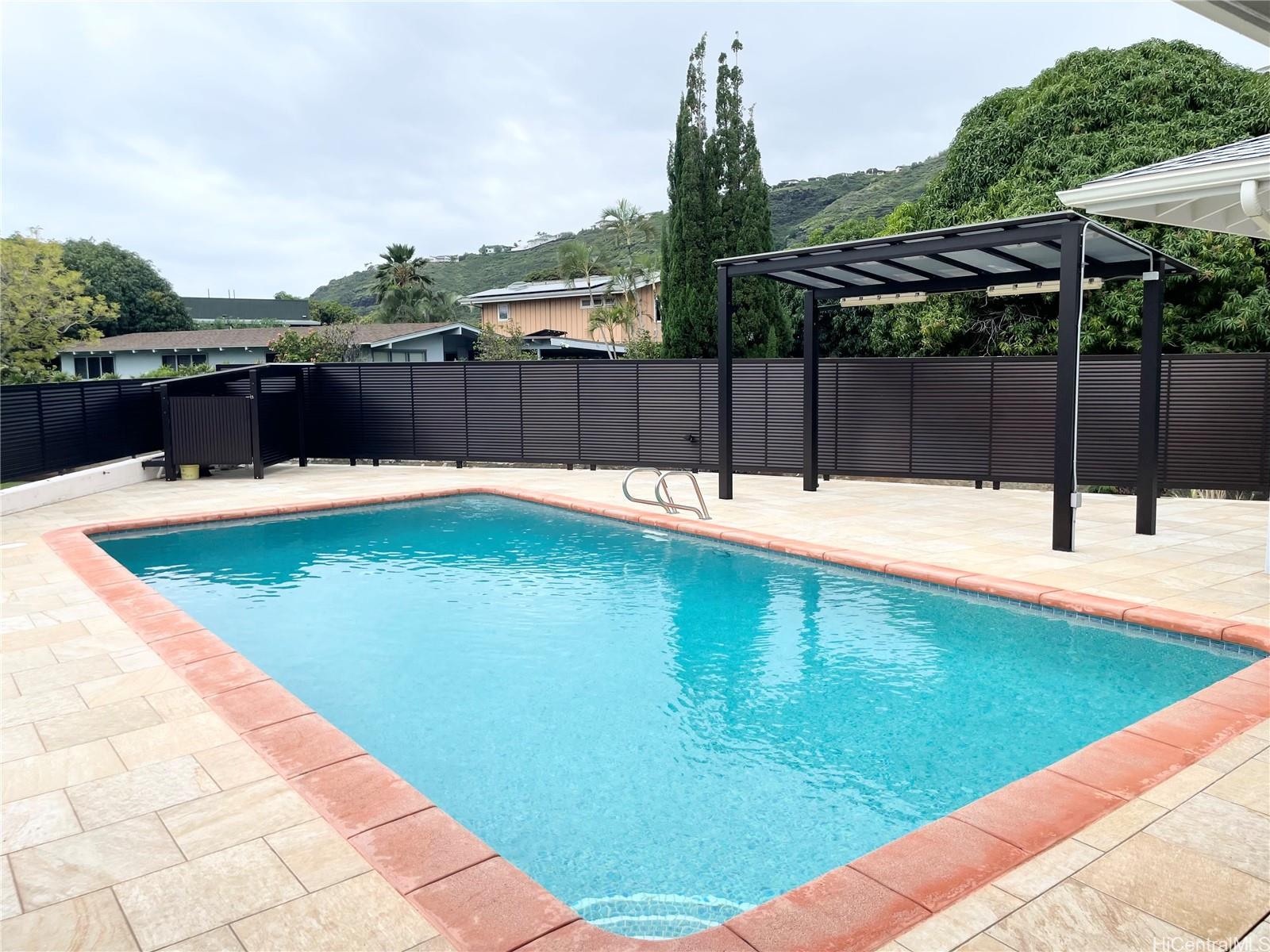 457 Halemaumau Street Honolulu, HI 96821 - Photo 20 of 25 a swimming pool with an outdoor seating