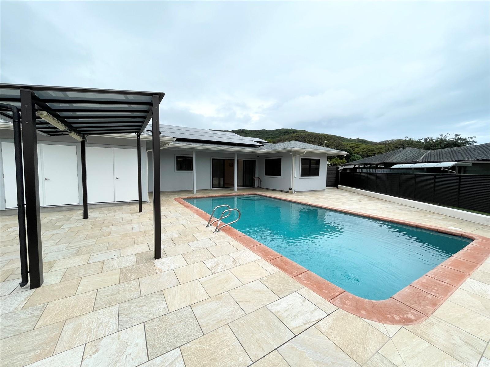 457 Halemaumau Street Honolulu, HI 96821 - Photo 21 of 25 a view of a house with a swimming pool