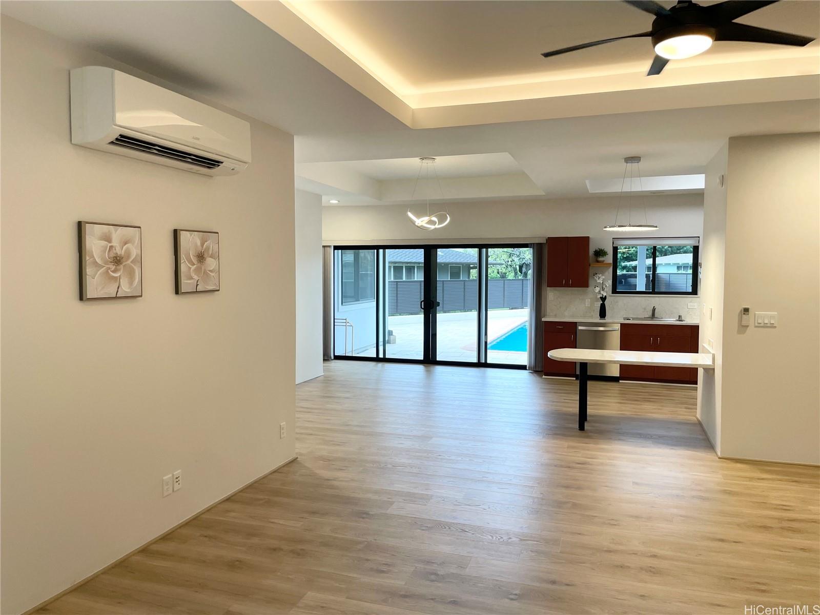 457 Halemaumau Street Honolulu, HI 96821 - Photo 5 of 25 a view of empty room with wooden floor and windows