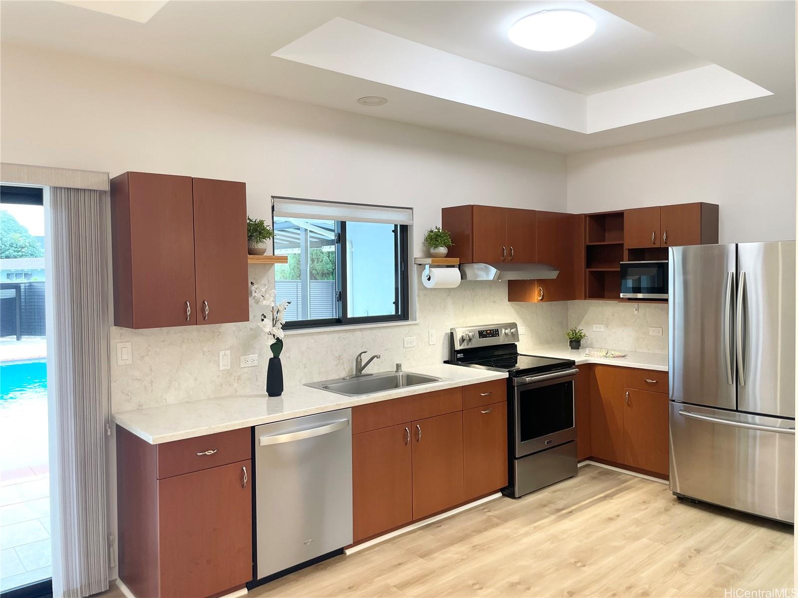 457 Halemaumau Street Honolulu, HI 96821 - Photo 7 of 25 a kitchen with stainless steel appliances granite countertop a sink stove and refrigerator