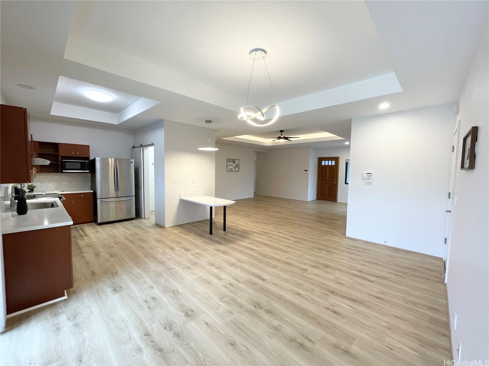 457 Halemaumau Street Honolulu, HI 96821 - Photo 9 of 25 a view of a livingroom with a kitchen