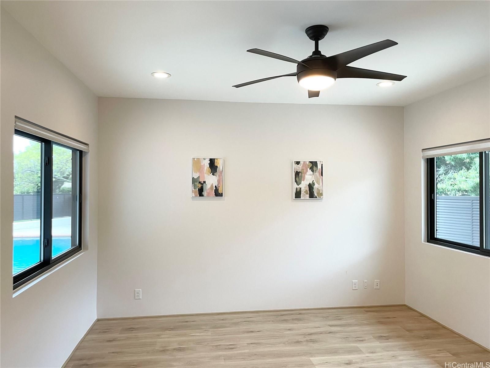 457 Halemaumau Street Honolulu, HI 96821 - Photo 10 of 25 a view of a livingroom with a window and wooden floor