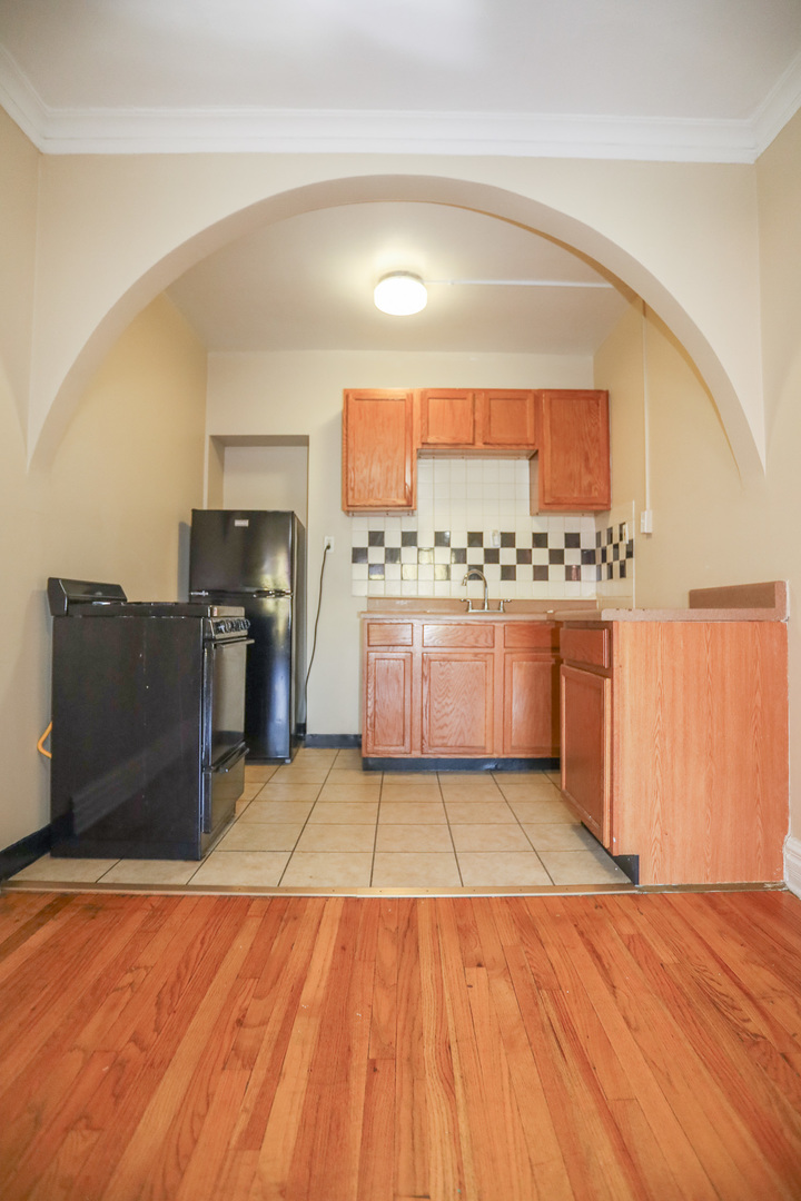 5417 South Harper Avenue, Unit 3A Chicago, IL 60615 - Photo 1 of 8 a view of kitchen with cabinets and wooden floor