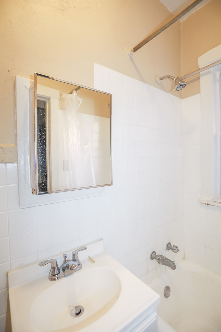 5417 South Harper Avenue, Unit 3A Chicago, IL 60615 - Photo 5 of 8 a bathroom with a sink and a mirror