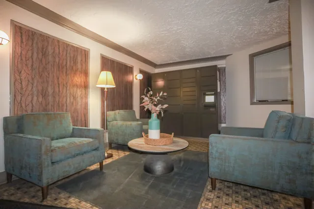 a living room with furniture and a mirror