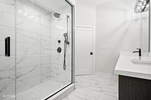 a bathroom with a shower and a sink