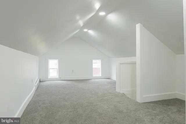 a view of a house with a big yard and large tree