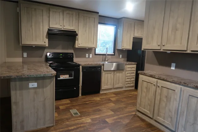 a kitchen with a sink and cabinets