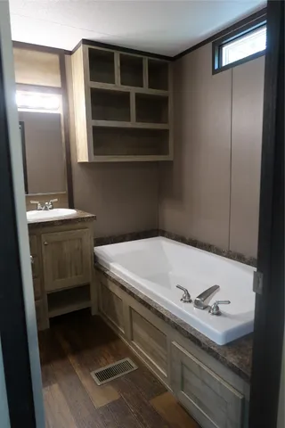 a bathroom with a sink a toilet and a mirror