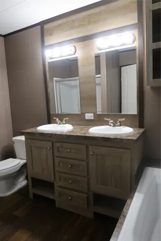 a bathroom with a double vanity sink and a mirror