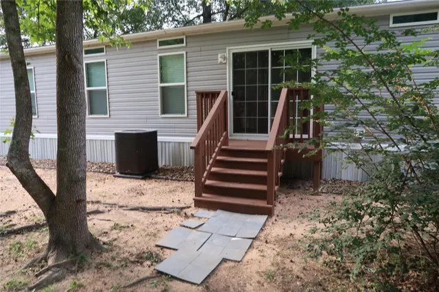a view of house with backyard and trees