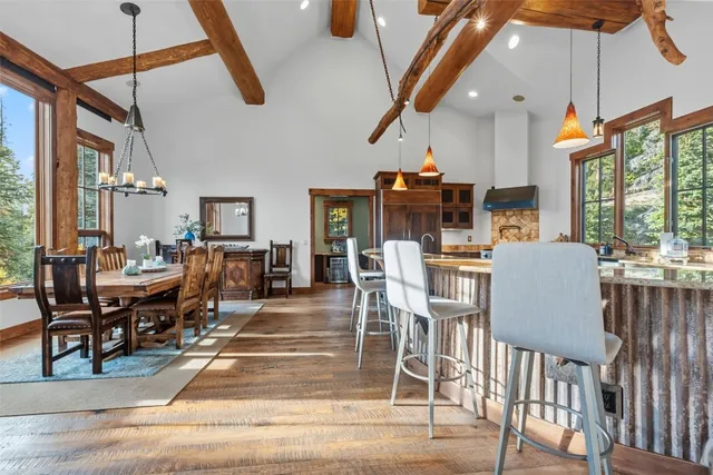 a dining room with furniture a chandelier and wooden floor