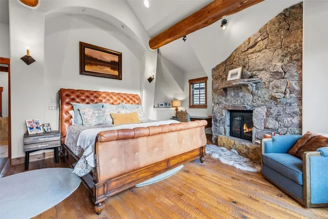 a bedroom with a bed and a fireplace