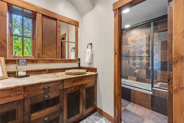 a view of a granite countertop sink and a window