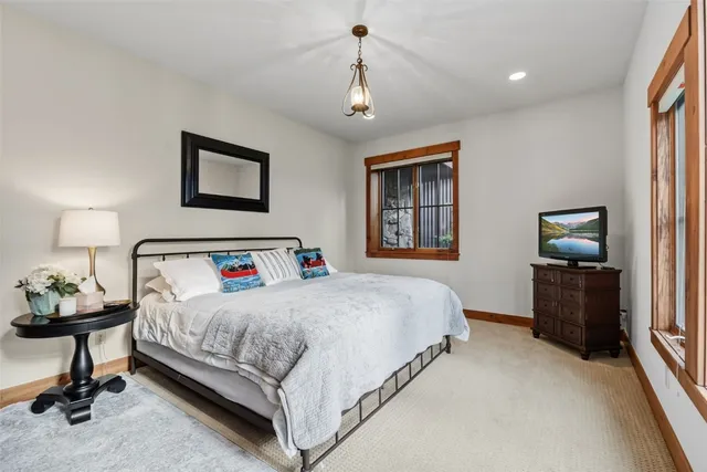 a bedroom with a bed and a chandelier