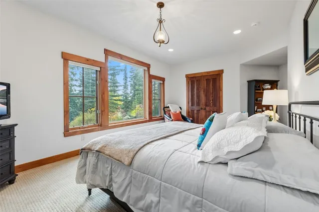 a bedroom with a large bed and a window