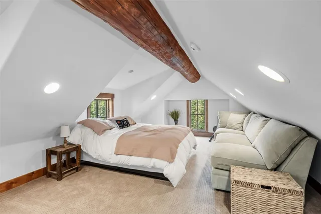 a bedroom with a bed a couch and dresser