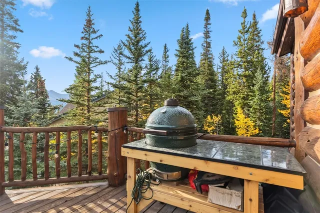 a view of deck with furniture and trees