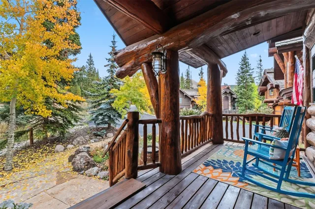 a view of a balcony with wooden floor and iron gate