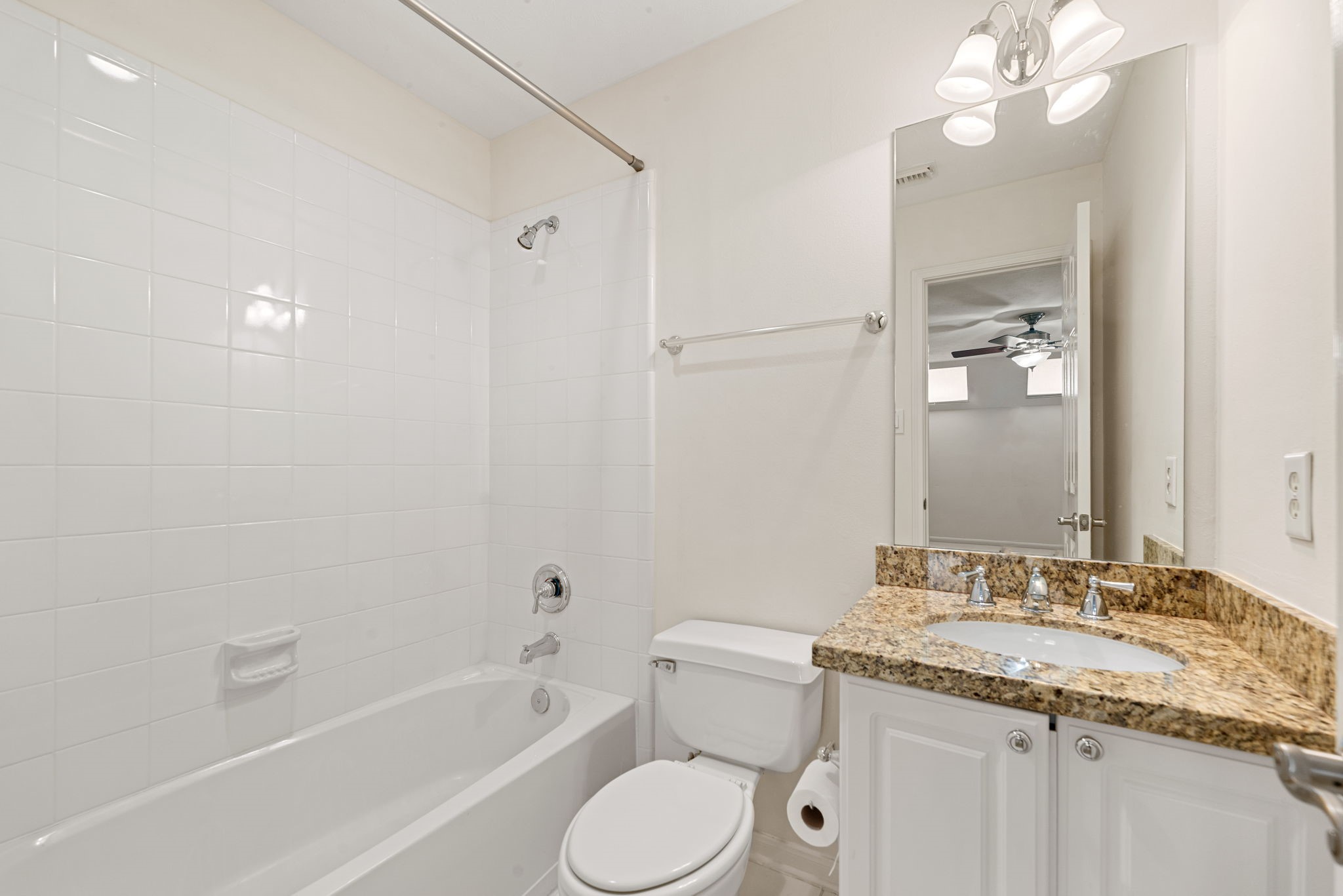 5318 Fayette Street Houston, TX 77056 - Photo 27 of 35 a bathroom with a granite countertop sink toilet a large mirror a shower and bathtub