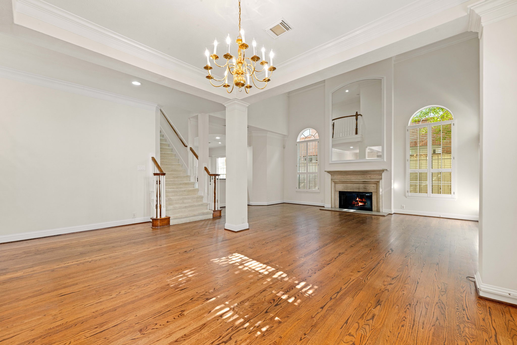 5318 Fayette Street Houston, TX 77056 - Photo 5 of 35 a view of an empty room with wooden floor fireplace and a window