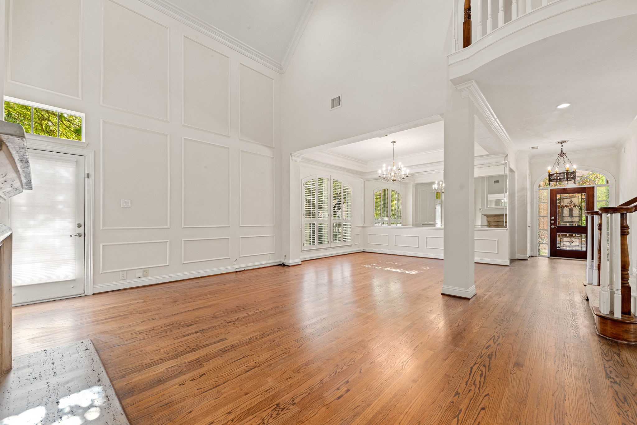 5318 Fayette Street Houston, TX 77056 - Photo 6 of 35 a view of an empty room with wooden floor and a kitchen