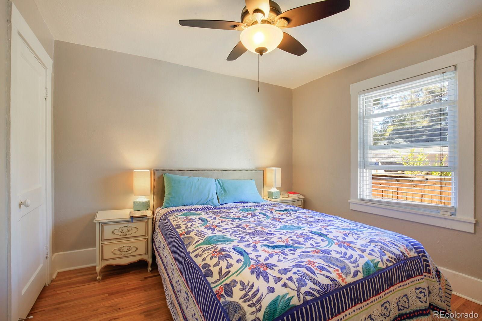 3877 Perry Street Denver, CO 80212 - Photo 13 of 23 a bedroom with a bed and wooden floor