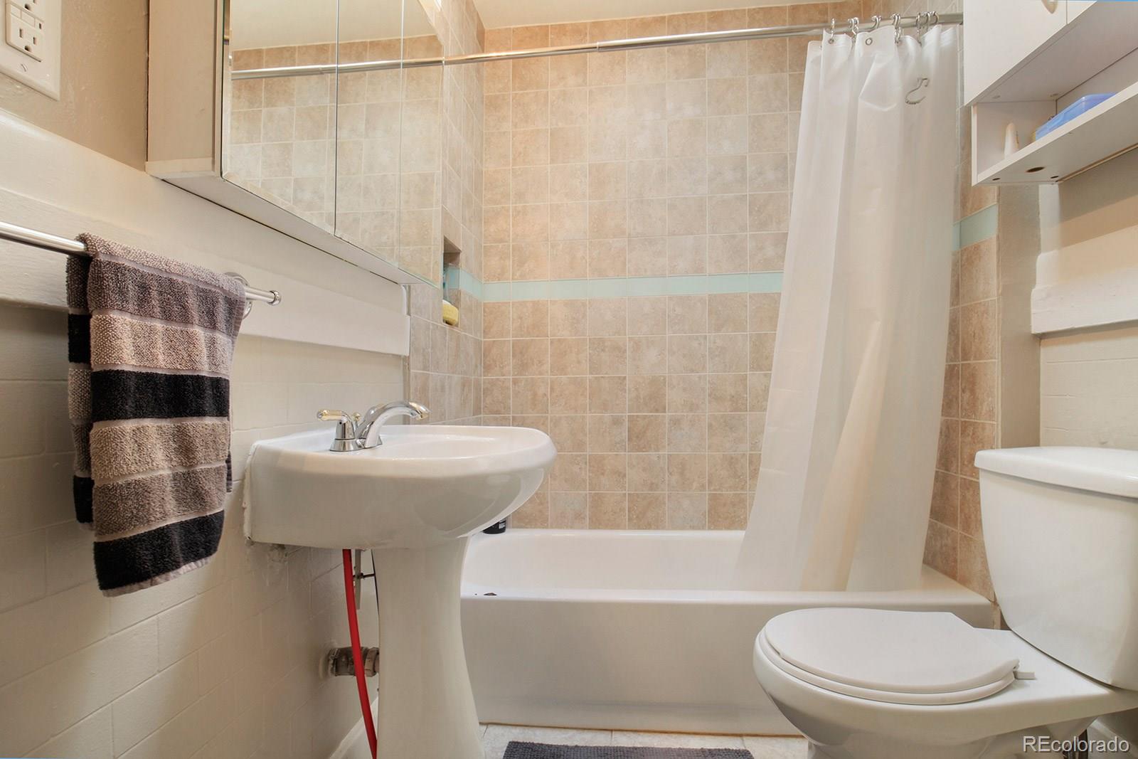 3877 Perry Street Denver, CO 80212 - Photo 14 of 23 a bathroom with a sink toilet and shower