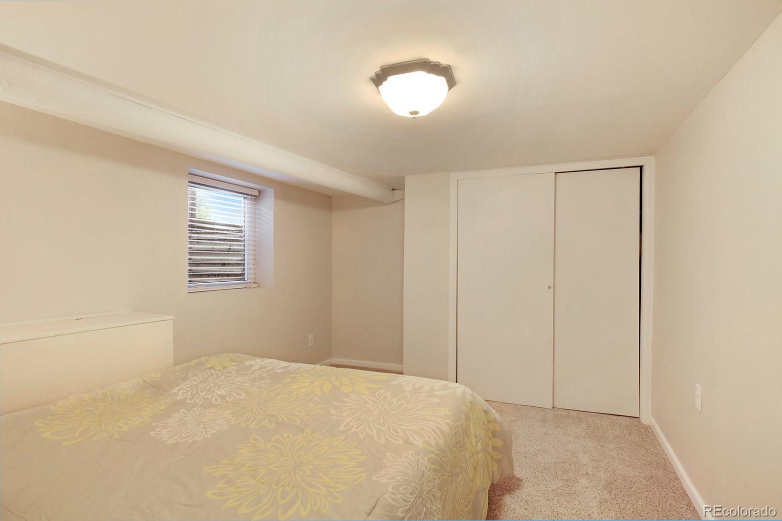 3877 Perry Street Denver, CO 80212 - Photo 17 of 23 a bedroom with a bed and a window