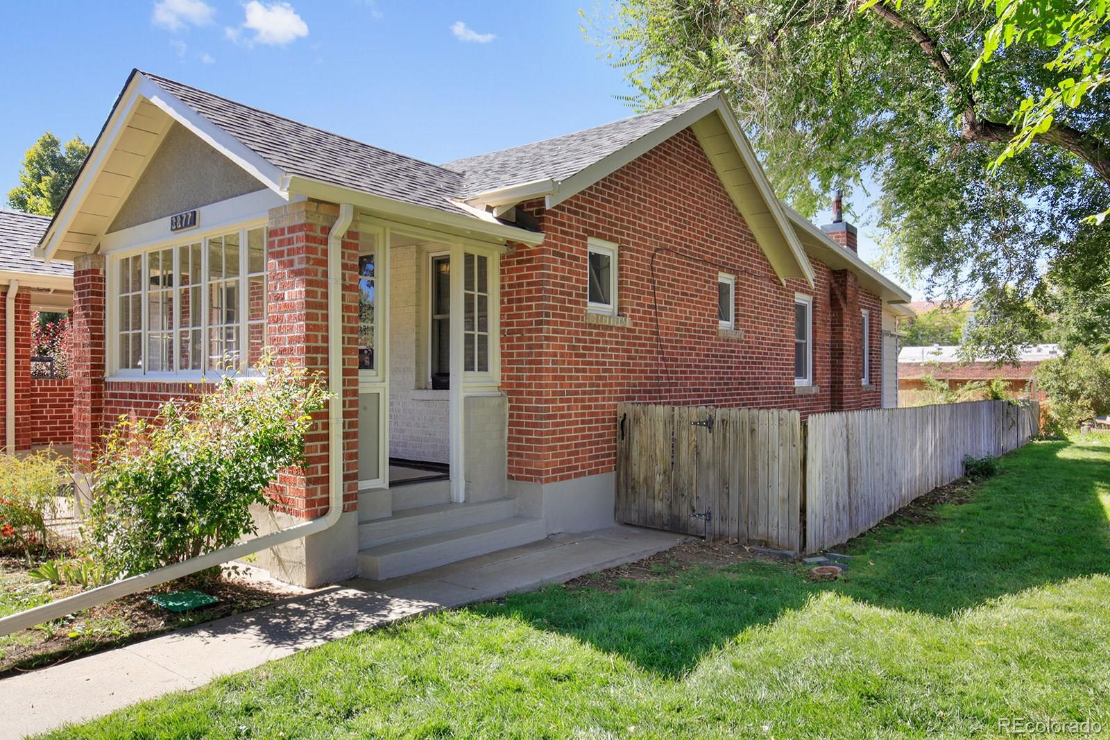 3877 Perry Street Denver, CO 80212 - Photo 2 of 23 a front view of a house with garden