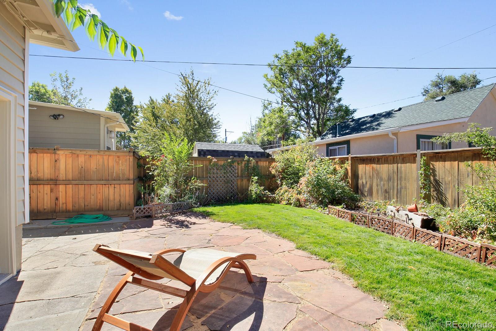 3877 Perry Street Denver, CO 80212 - Photo 21 of 23 a view of a backyard with table and chairs and potted plants