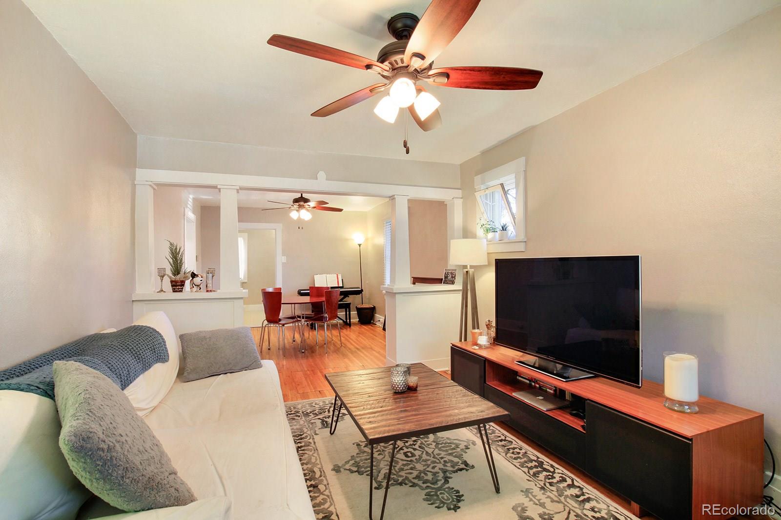 3877 Perry Street Denver, CO 80212 - Photo 5 of 23 a living room with furniture and a flat screen tv