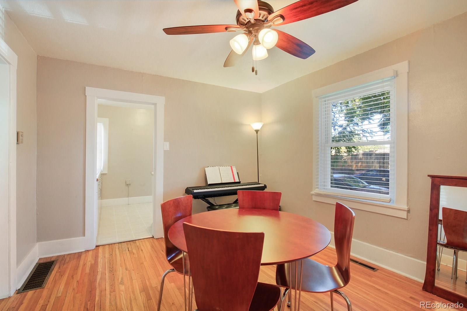 3877 Perry Street Denver, CO 80212 - Photo 7 of 23 a view of a dining room with furniture window and wooden floor