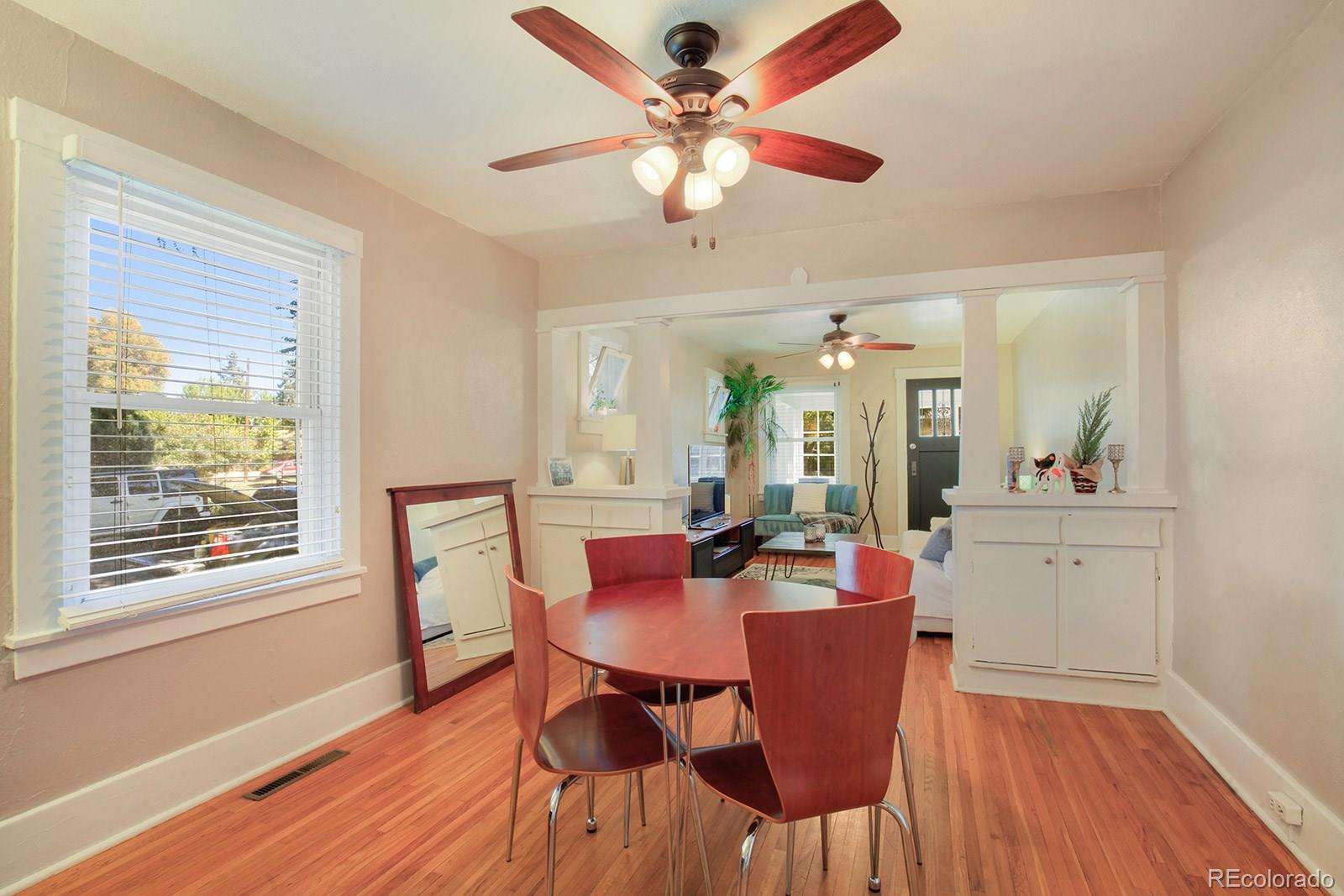 3877 Perry Street Denver, CO 80212 - Photo 8 of 23 a view of a dining room with furniture window and wooden floor
