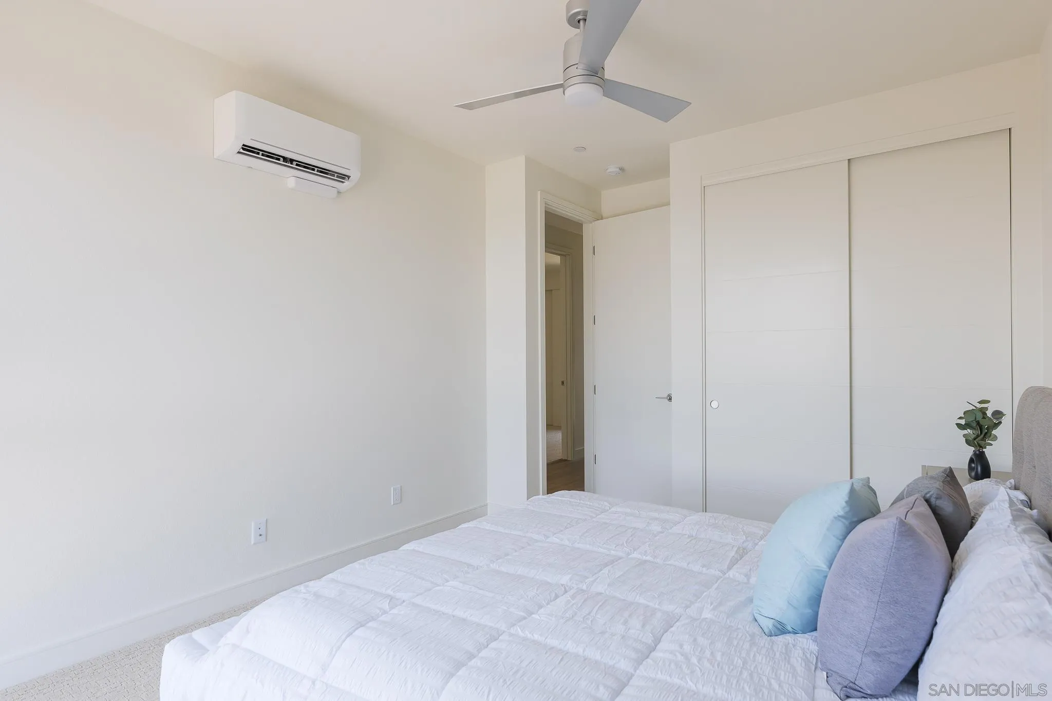 8244 High Street La Mesa, CA 91941 - Photo 17 of 27 a bedroom with a bed and a chandelier fan