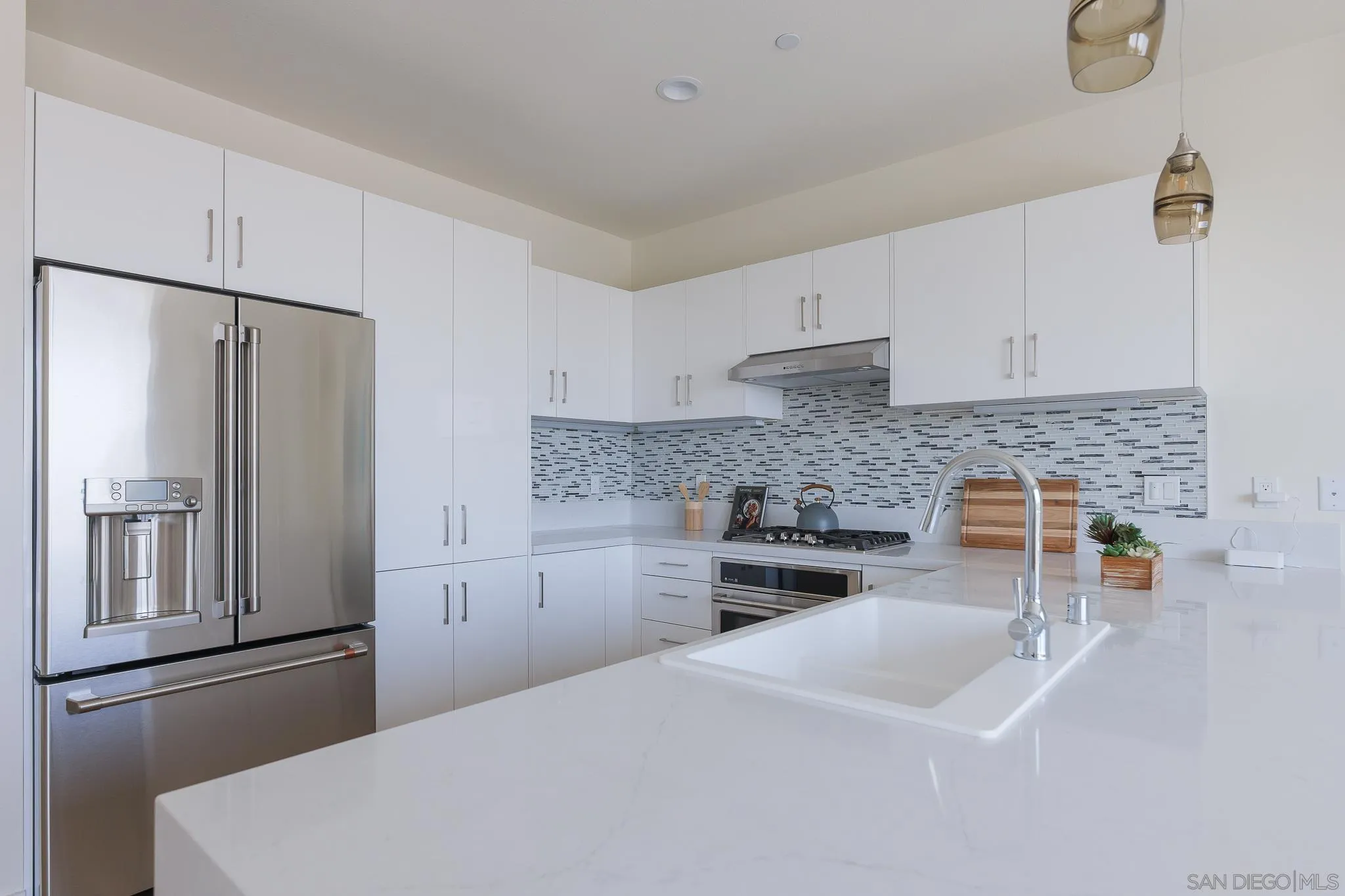 8244 High Street La Mesa, CA 91941 - Photo 5 of 27 a kitchen with a refrigerator sink and cabinets