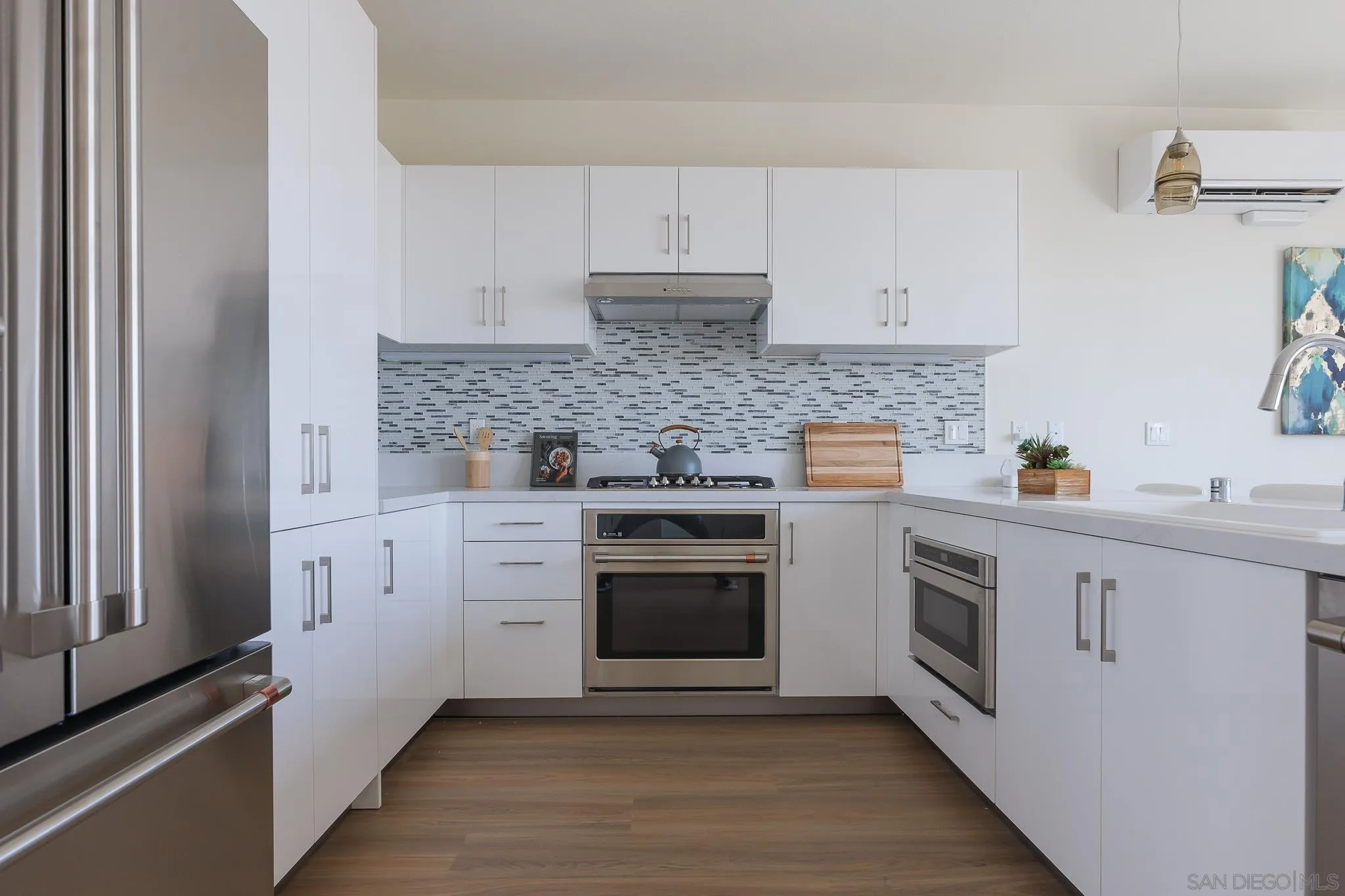 8244 High Street La Mesa, CA 91941 - Photo 6 of 27 a kitchen with white cabinets stainless steel appliances and sink