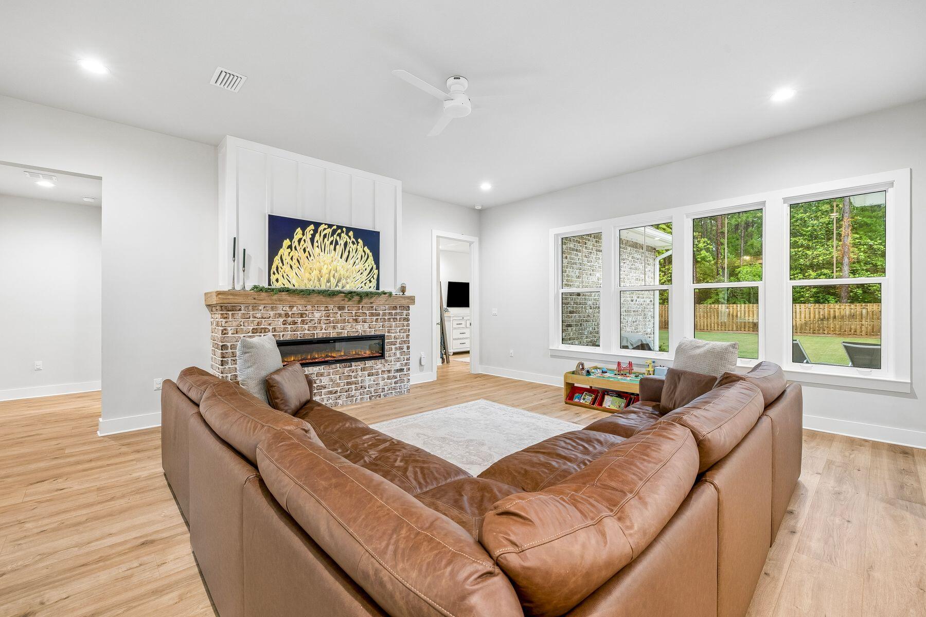 39 West Captain Fritz Way Freeport, FL 32439 - Photo 5 of 33 a living room with furniture a fireplace and a large window