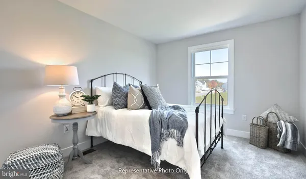 a bedroom with a bed and a lamp