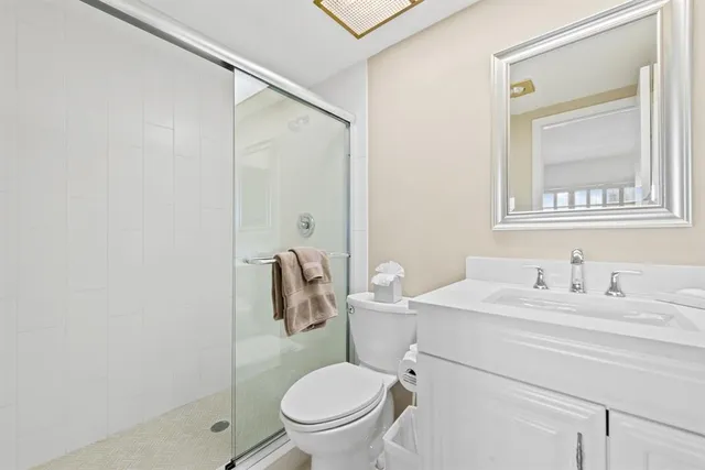 a bathroom with a sink toilet and mirror